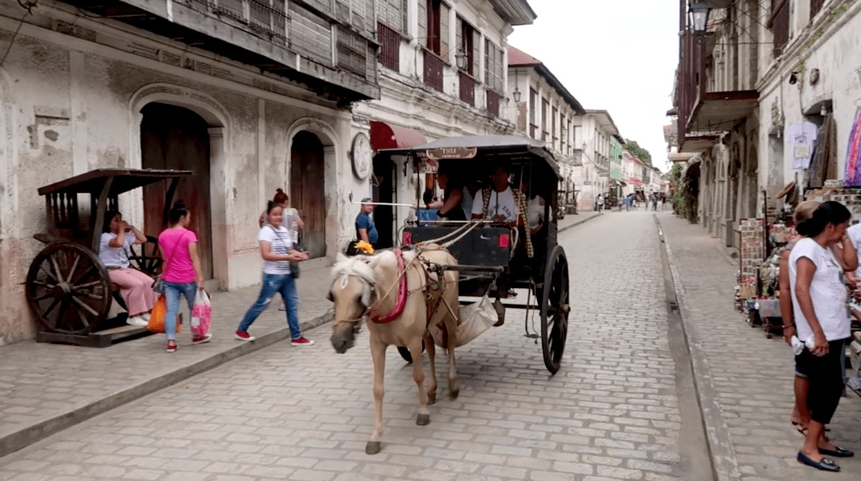 kalesa horse carriage riding through the calle crisologo famous touristic street in vigan city ilocos sur philippines