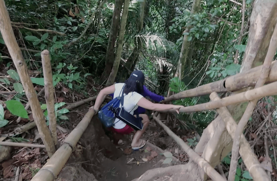 a steep natural stairs down as the hard trail to hulugan falls waterfall in laguna province philippines
