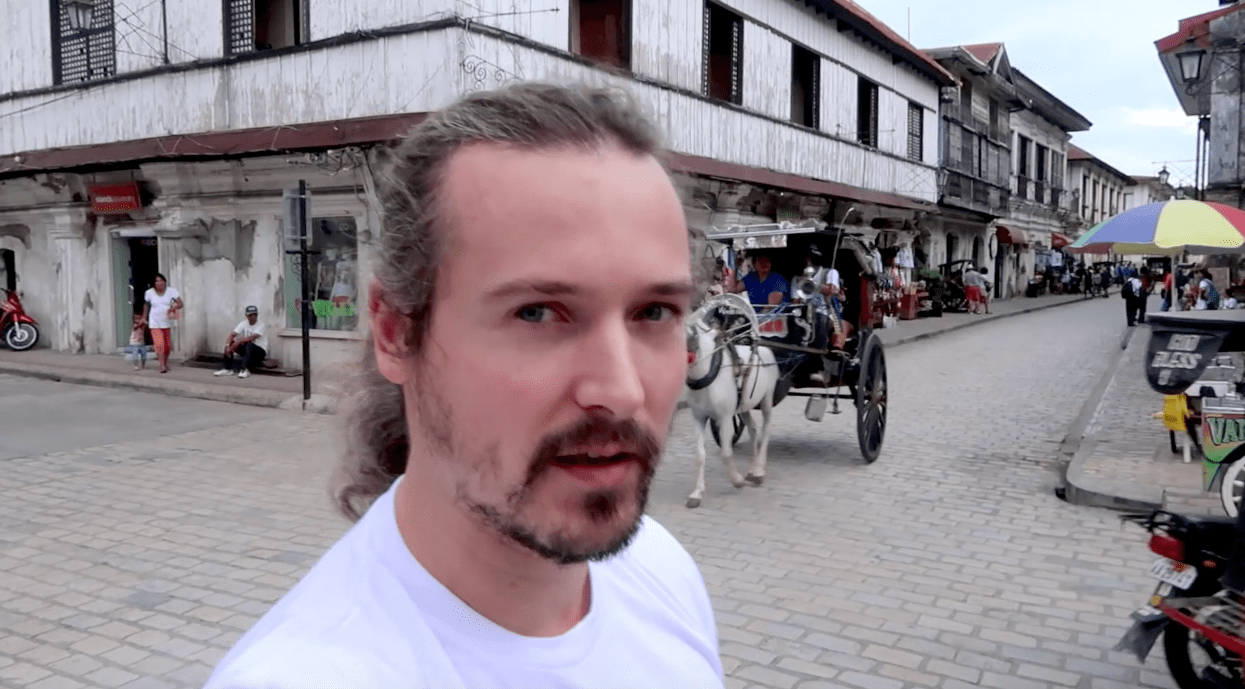 lenny through paradise standing with calle crisologo the background, in vigan, ilocos sur, philippines