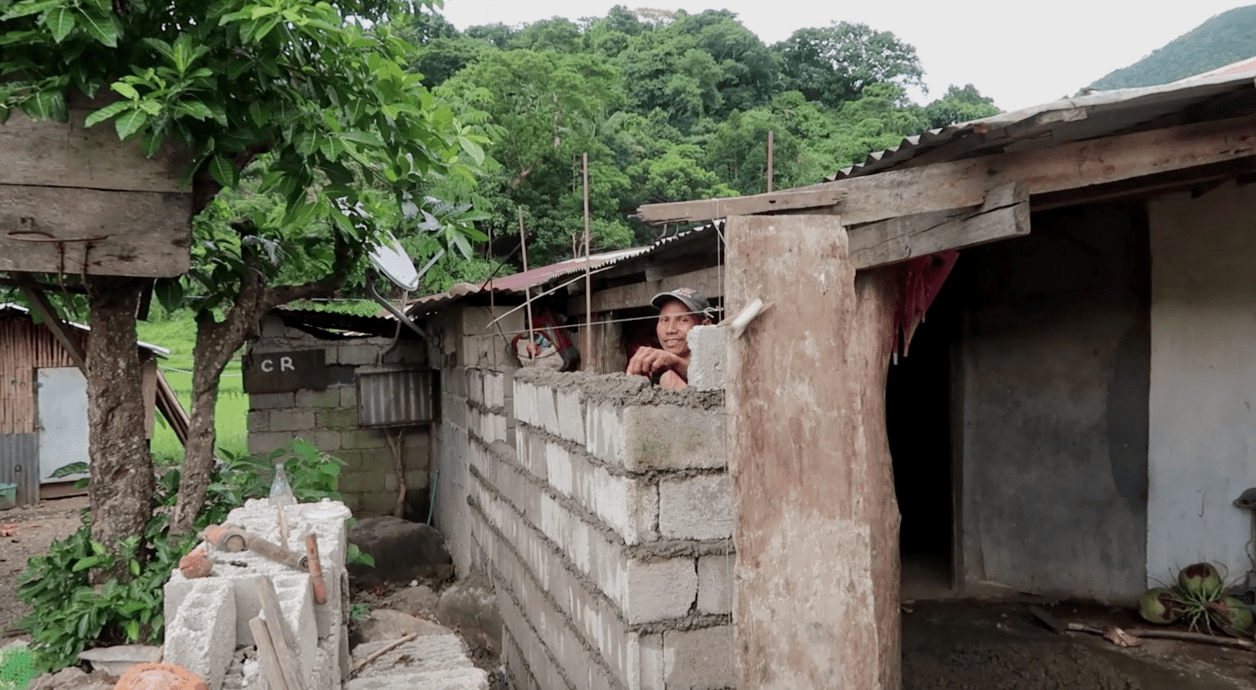 a filipino laying bricks and building a wall in pagudpud ilocos norte philippines