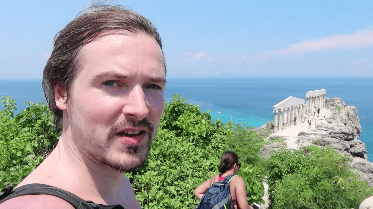 Man going towards the acropolis greek strucure on fortune island batangas philippines