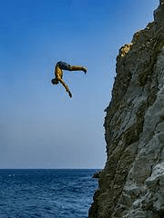 man cliff diving