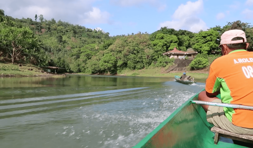 motorboat pulls canoe forward to pagsanjan falls laguna philippines