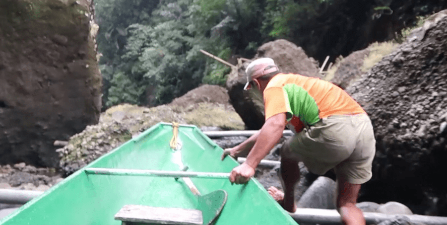 boatmen pusing canoe through river stream upwards to the pagsanjan falls laguna philippines