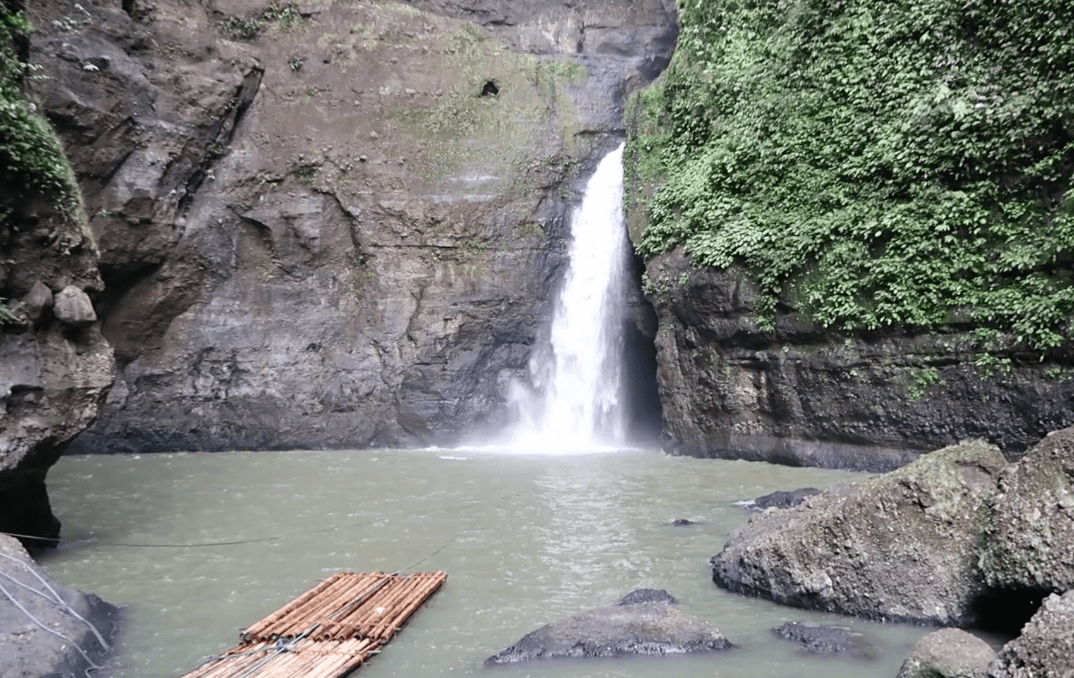 the pagsanjan waterfall in laguna philippines with wooden rafts available to take you into the pagsanjan falls