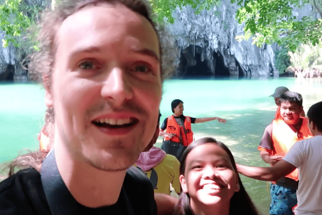 Lenny Through Paradise with Melody Somido in front of the Puerto Princesa Underground River in Palawan, smiling