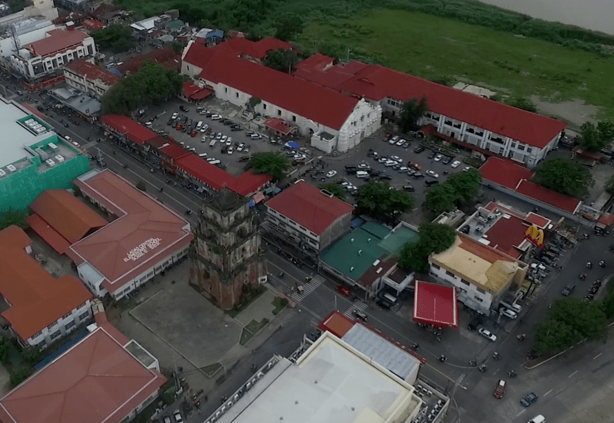 The sinking belltower in laoag city in ilocos norte philippines. seen from the sky shot by drone flight.
